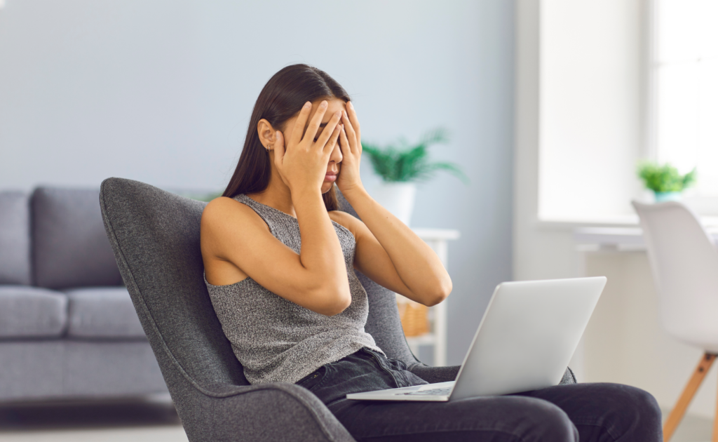 Frustrated lady sitting with a laptop