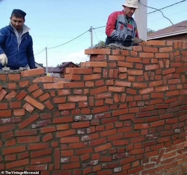 Two bricklayers constructing a wall of haphazardly arranged bricks