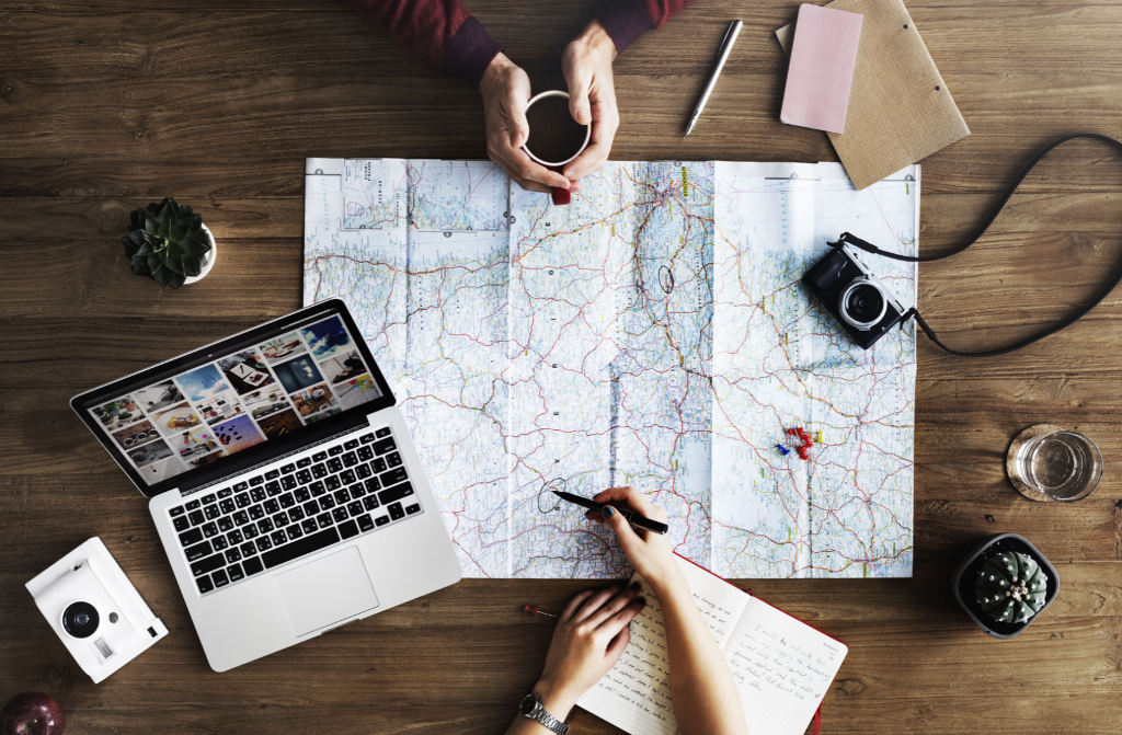 Two people looking at a map, planning a trip